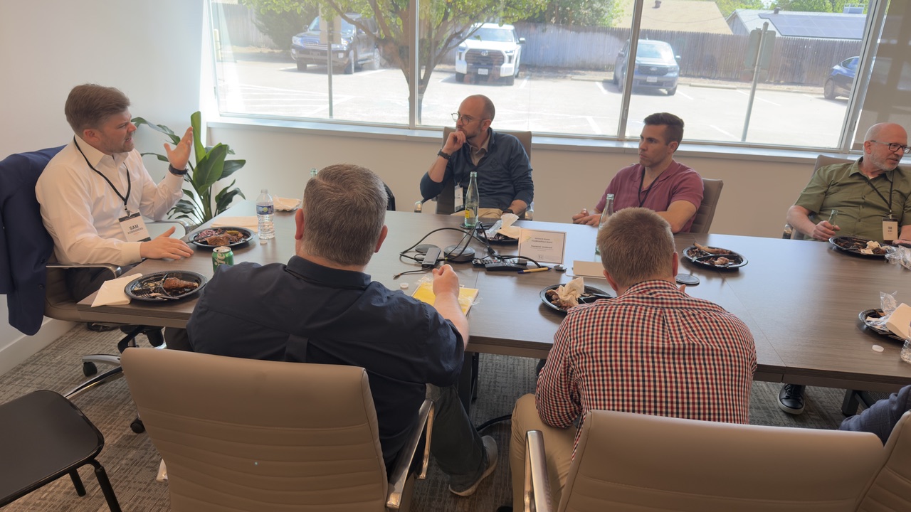 Speakers leading small-group coaching conversations during the lunch break