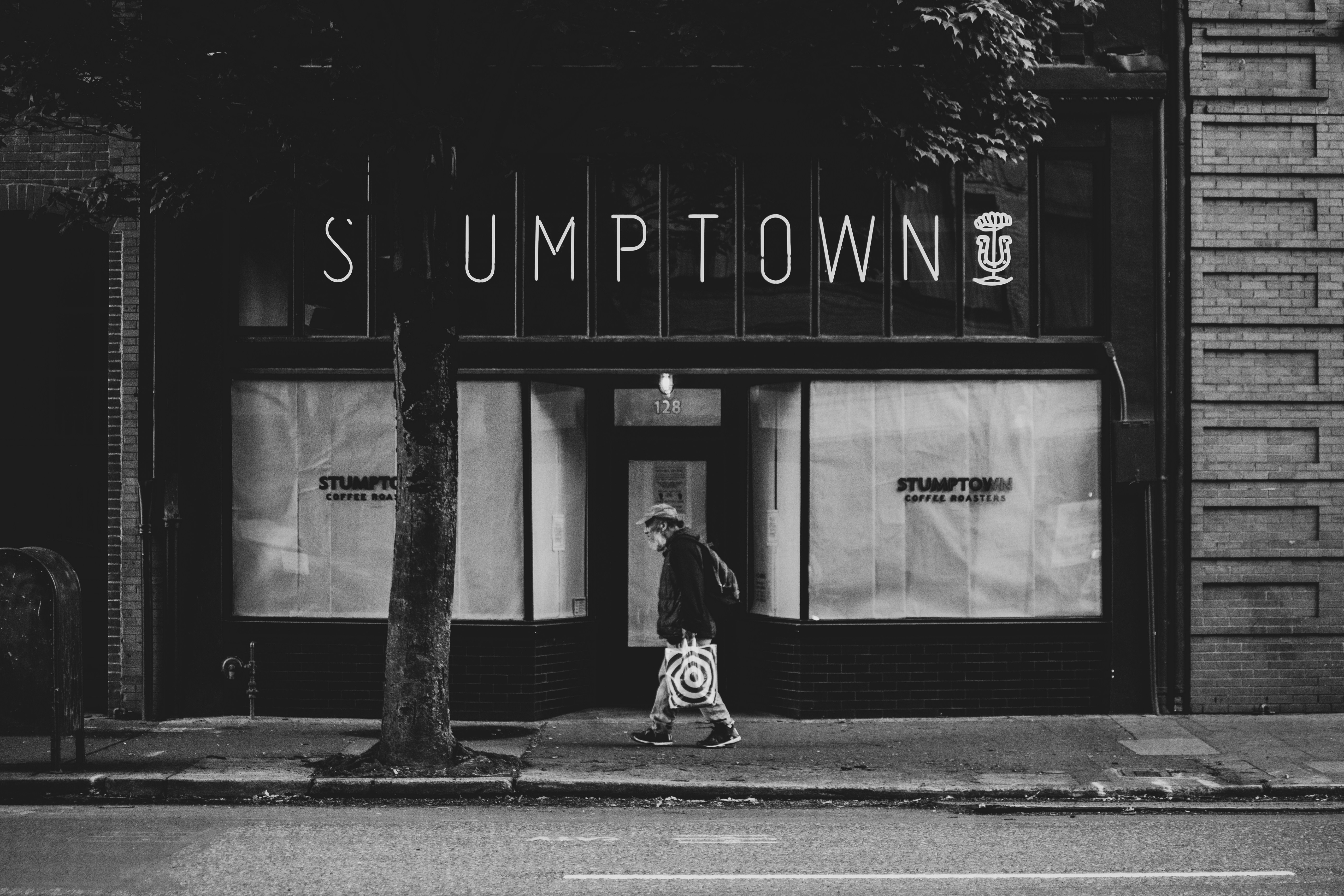 Man walking past Stumptown storefront